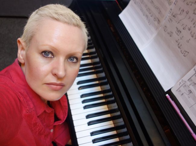 Female with short blonde hair at piano